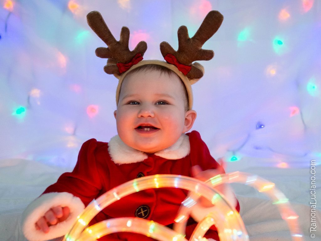 Ramona as Mrs. Claus wearing antlers.